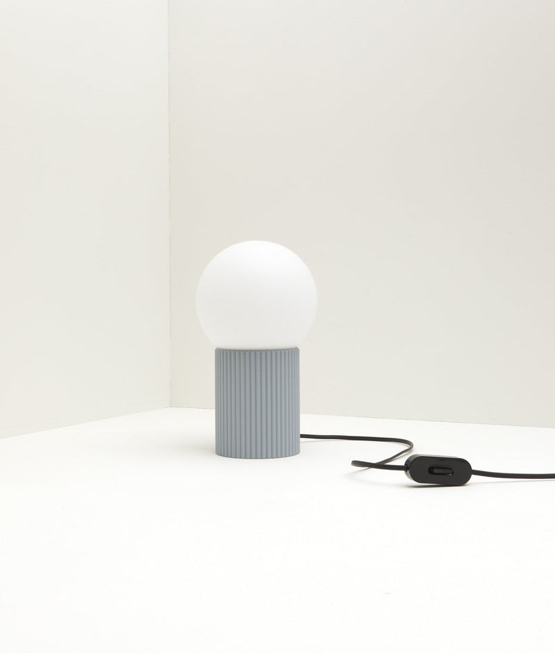 Lampe à poser "Colonnade", base à fines cannelures, verrerie boule mate, bleu glacier